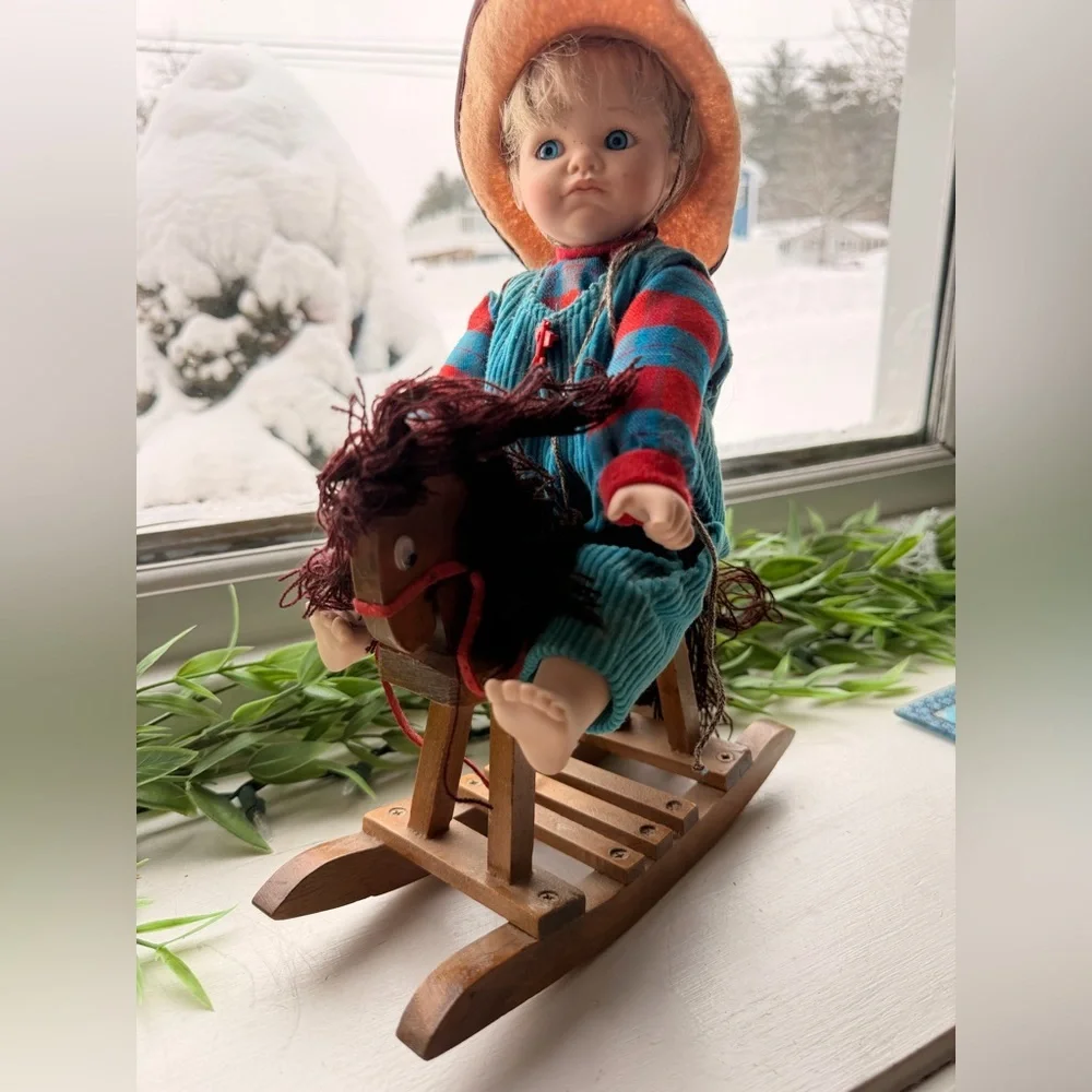 Doll in Striped Outfit on Rocking Horse